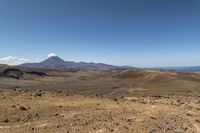 a barren area with rocks and rocks in front of mountains that are in the distance
