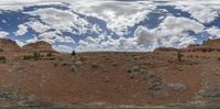 some rocks and some clouds are in the sky in this 360 - shot photograph too