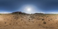 a 360 - 360 lens image of a desert plain with a sun in the background