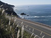 a highway running along side of the ocean with a highway along both sides of it