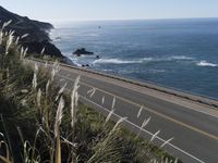 a highway running along side of the ocean with a highway along both sides of it