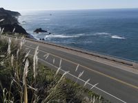 a highway running along side of the ocean with a highway along both sides of it