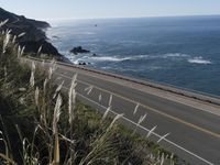 a highway running along side of the ocean with a highway along both sides of it