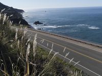 a highway running along side of the ocean with a highway along both sides of it