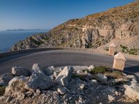 an image of a mountain road by the ocean in the afternoon light taken at dawn