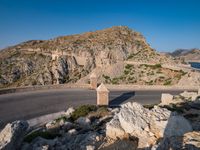 an image of a mountain road by the ocean in the afternoon light taken at dawn