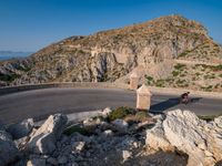 an image of a mountain road by the ocean in the afternoon light taken at dawn