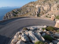 an image of a mountain road by the ocean in the afternoon light taken at dawn