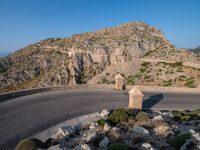 an image of a mountain road by the ocean in the afternoon light taken at dawn