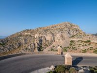 an image of a mountain road by the ocean in the afternoon light taken at dawn