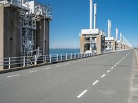 this is a highway leading to two industrial chimneys on the other side of the sea