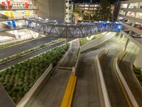 a view of a road and an overpass with traffic passing through it by buildings