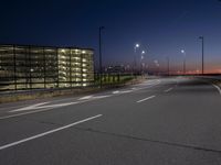 a highway with street lights on both sides and two lanes running through the center of the image