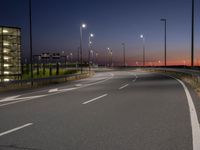 a highway with street lights on both sides and two lanes running through the center of the image