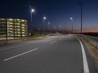 a highway with street lights on both sides and two lanes running through the center of the image