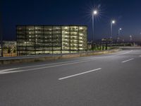 a highway with street lights on both sides and two lanes running through the center of the image