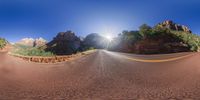 an open highway and mountain in the background on a sunny day in zion, utah