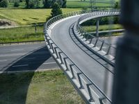 a view from a window of traffic on a highway with a bike path below them