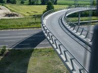 a view from a window of traffic on a highway with a bike path below them