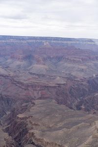 a hiker standing on the edge of a cliff in the grand canyon of south rim