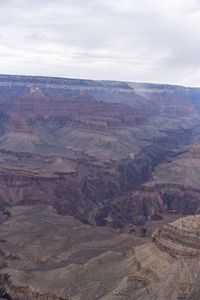 a hiker standing on the edge of a cliff in the grand canyon of south rim