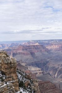 a hiker standing on the edge of a cliff in the grand canyon of south rim