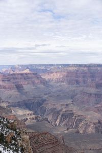 a hiker standing on the edge of a cliff in the grand canyon of south rim