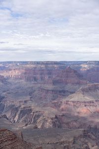 a hiker standing on the edge of a cliff in the grand canyon of south rim