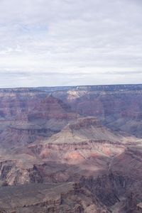 a hiker standing on the edge of a cliff in the grand canyon of south rim