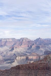 a hiker standing on the edge of a cliff in the grand canyon of south rim