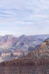 a hiker standing on the edge of a cliff in the grand canyon of south rim