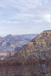 a hiker standing on the edge of a cliff in the grand canyon of south rim