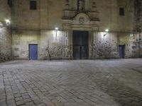 a clock sitting above the front entrance of a building at night in france to see a full set of lights