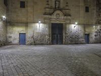 a clock sitting above the front entrance of a building at night in france to see a full set of lights