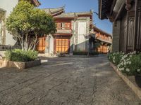 a cobblestone street leading to an old - fashioned house that looks like an oriental style village