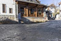 the old city street is empty except for people to travel around it with a car parked in front