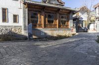 the old city street is empty except for people to travel around it with a car parked in front