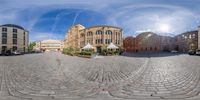 a fisheye lens that is on display in front of a building and other buildings