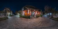 a 360 - view picture taken with a fisheye lens, with an old building lit up at night