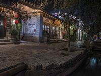 a street has been created around with lanterns on the windows and walls, a river runs through it and a signboard that reads'lucky to be lucky in chinese