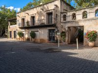 an old building is in a sunny day in a courtyard area of the old city