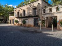 an old building is in a sunny day in a courtyard area of the old city