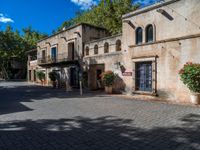 an old building is in a sunny day in a courtyard area of the old city