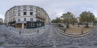 a 360 - shot is shown showing two buildings in a square area with cobblestones