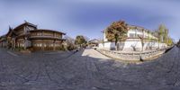 a 360 - view of houses in the middle of a street with cobblestone road