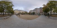 a view of a street through a 360 lens lens in a public area with old buildings