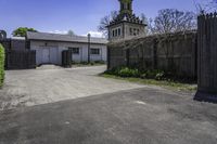 an old farm building with an entrance and gated area that leads to it's yard