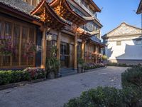 a cobblestone street in front of a building with decorative flowers on the windows