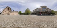 a street view of buildings in different stages of development at a historic town square with a circular lens