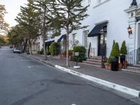 white brick sidewalk near building in town setting with lamp post and street lights on side walk